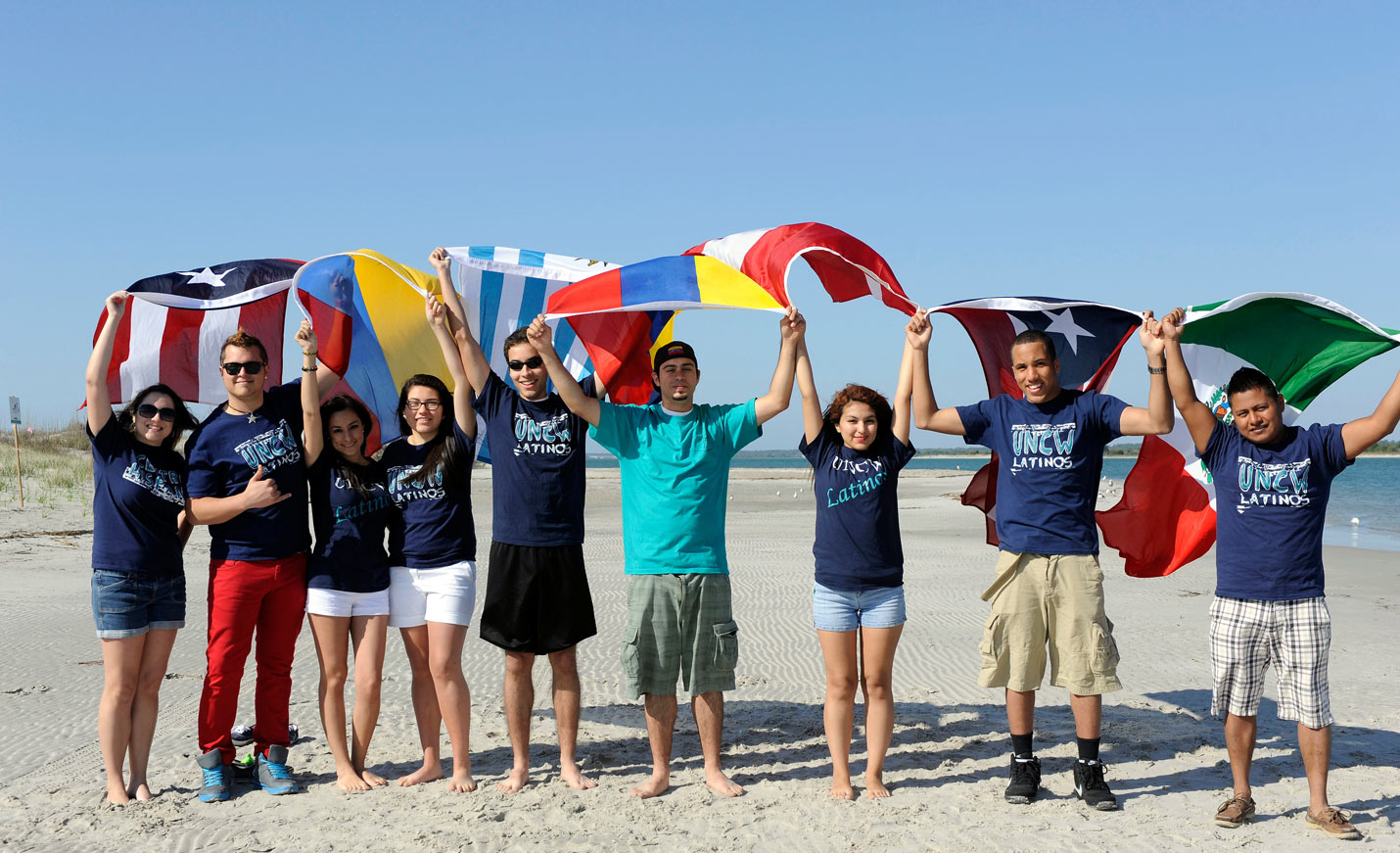 Centro Hispano students with flags on the beach