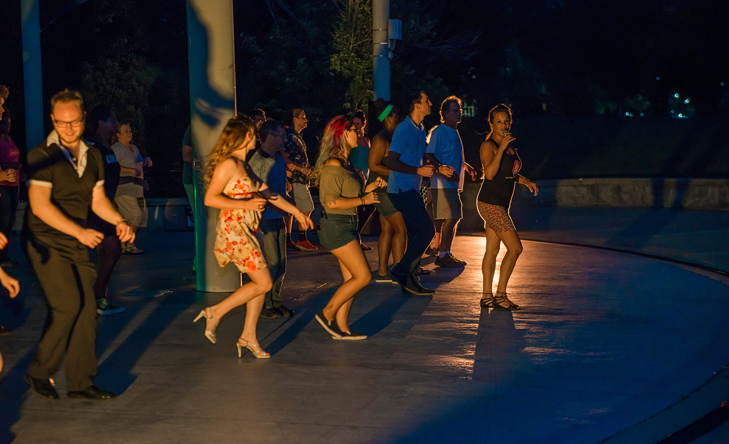 students dancing at night outdoors at a salsa festival