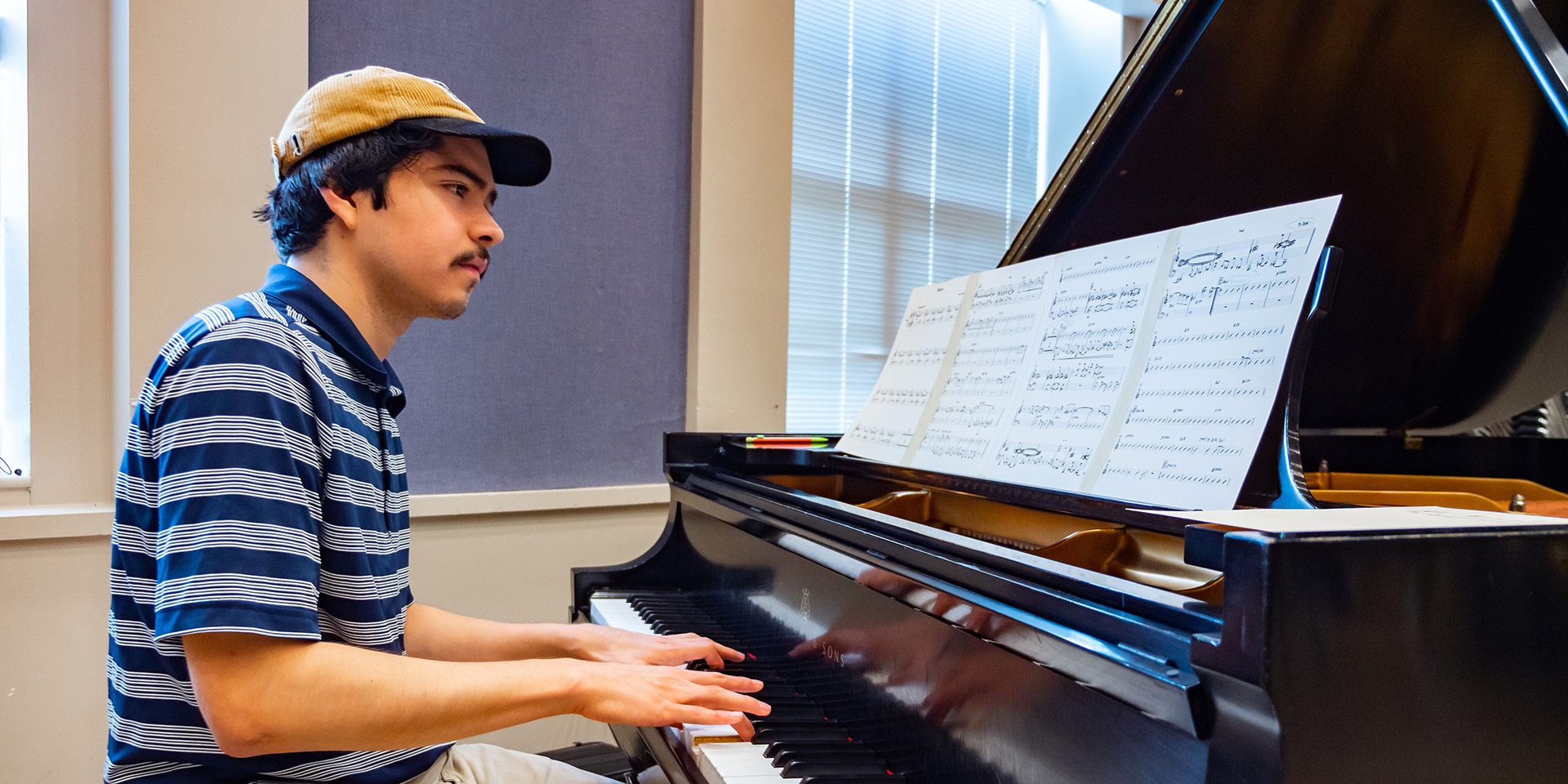 A student practicing the piano