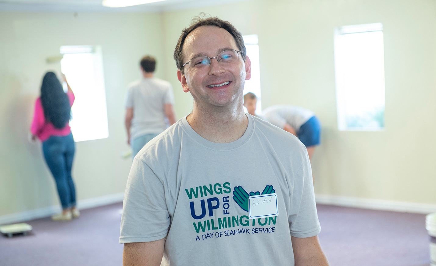 A man volunteering at Wings Up Wilmington wears a T-shirt bearing the event's logo