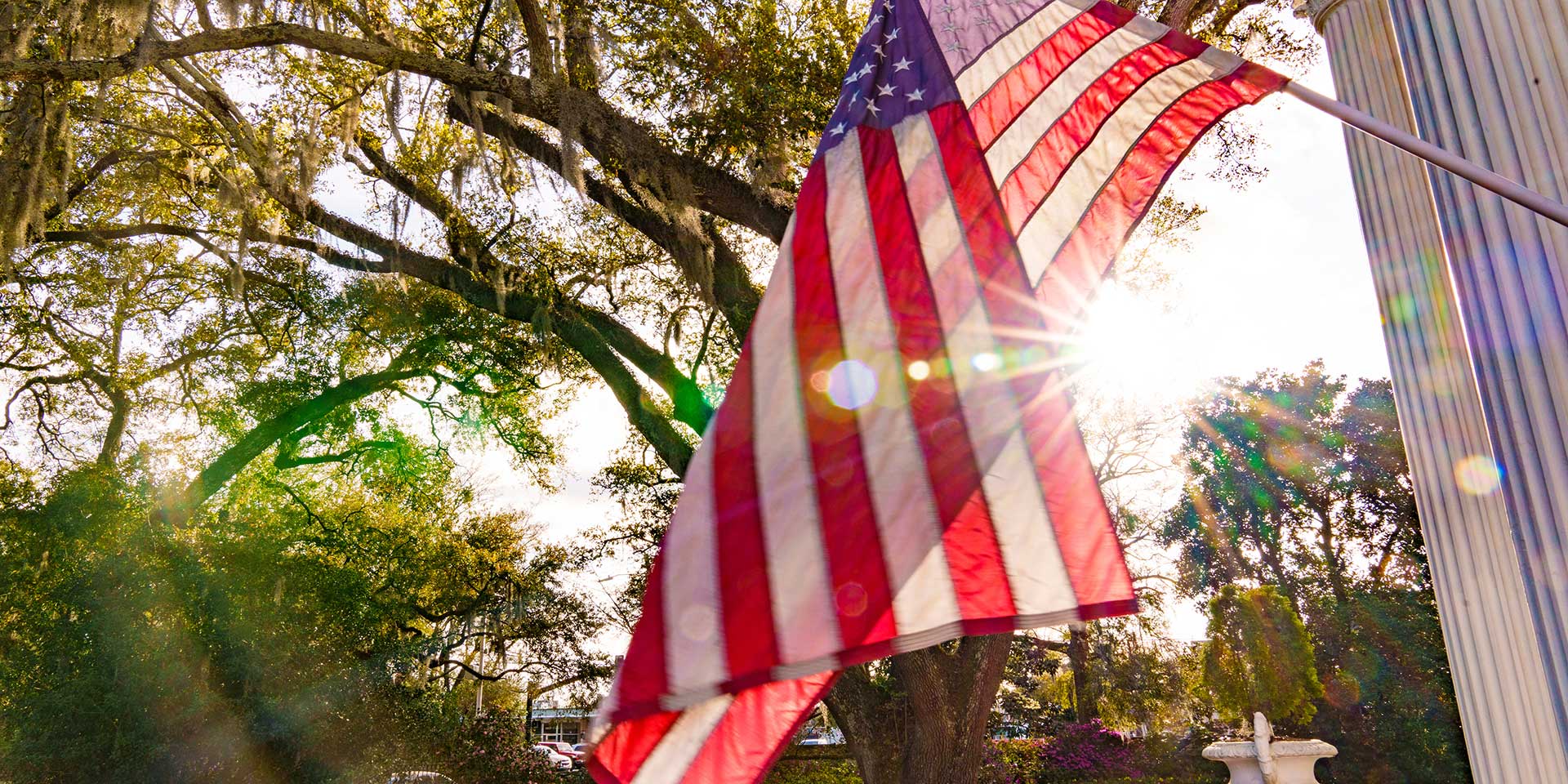 Sun shining through an American flag 
