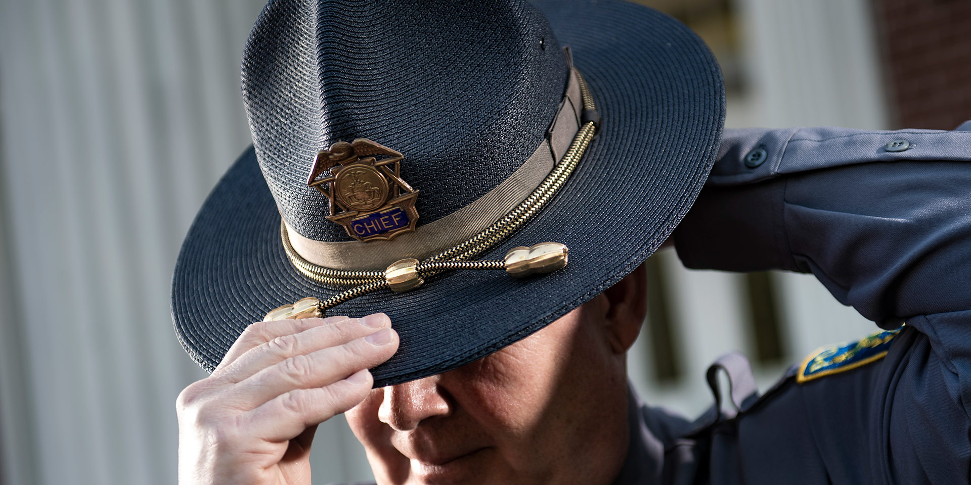 A police officer puts on a hat