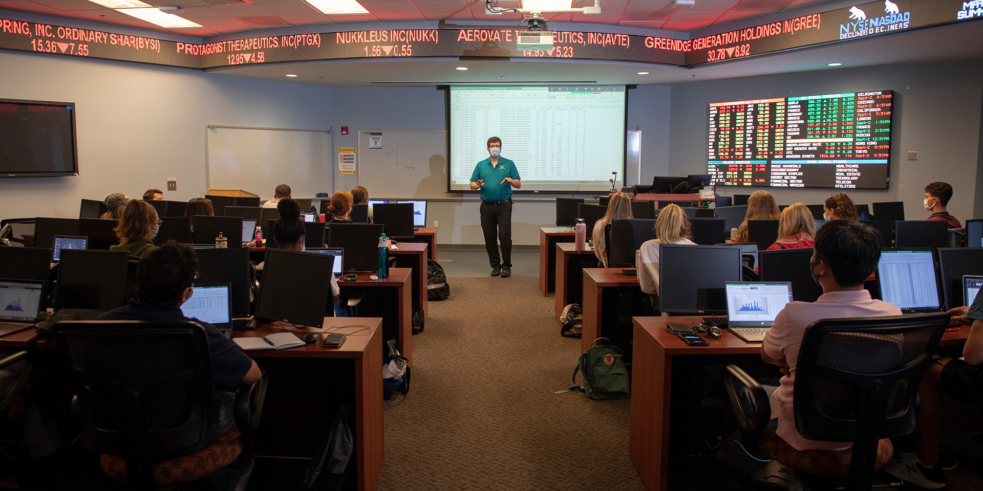 A professor gives a lecture in the Financial Markets Room