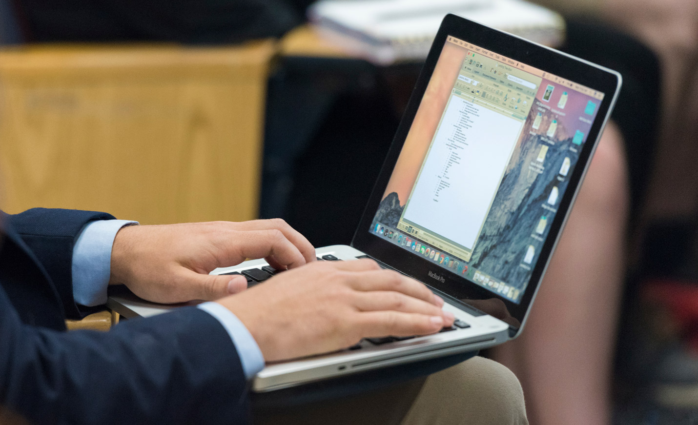 student holding laptop