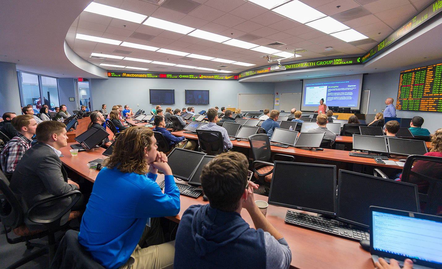 An audience of students listens to a lecture during a conference