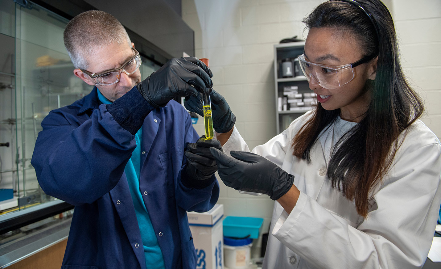 scientists examine beaker
