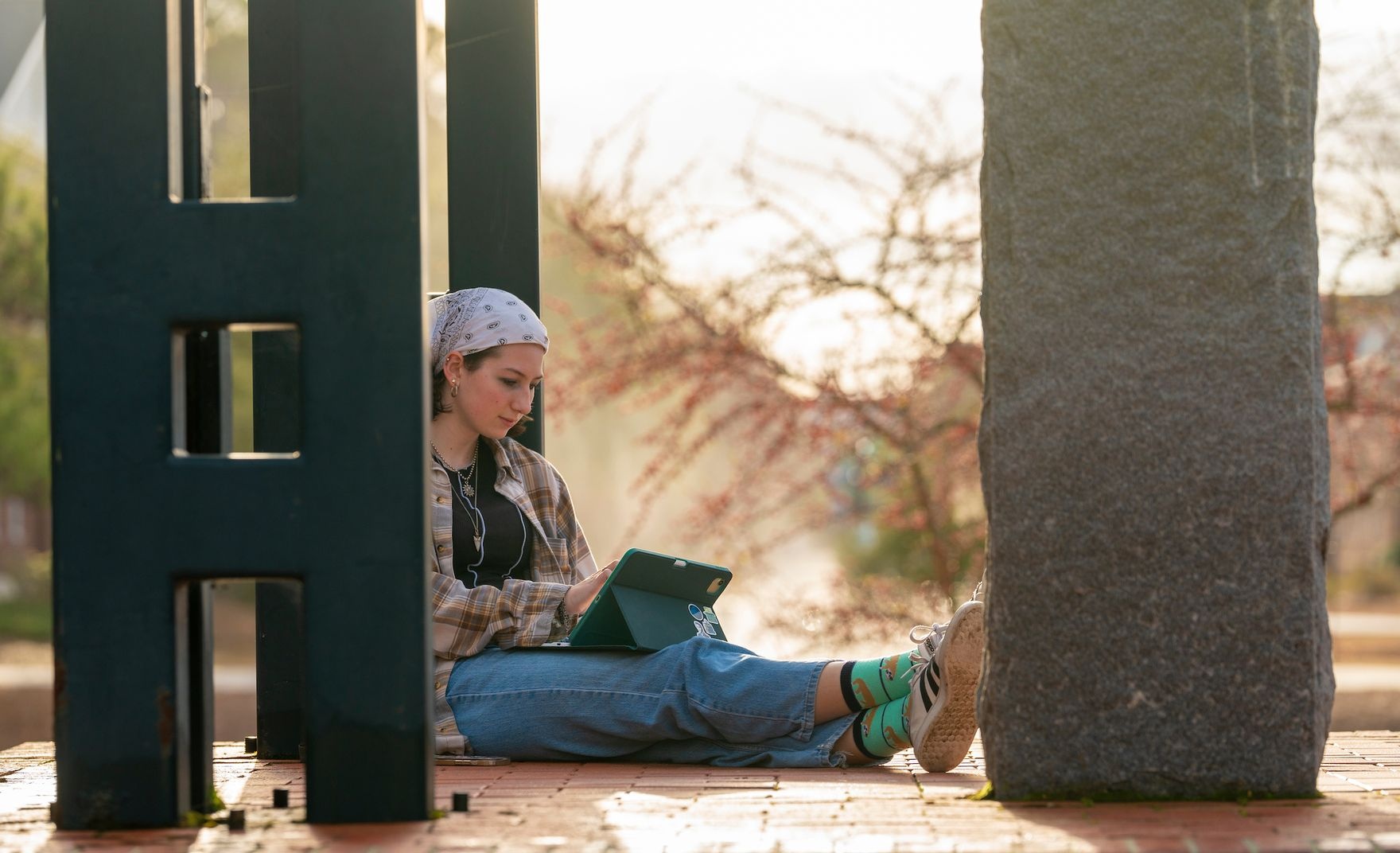 student sitting outside with her ipad