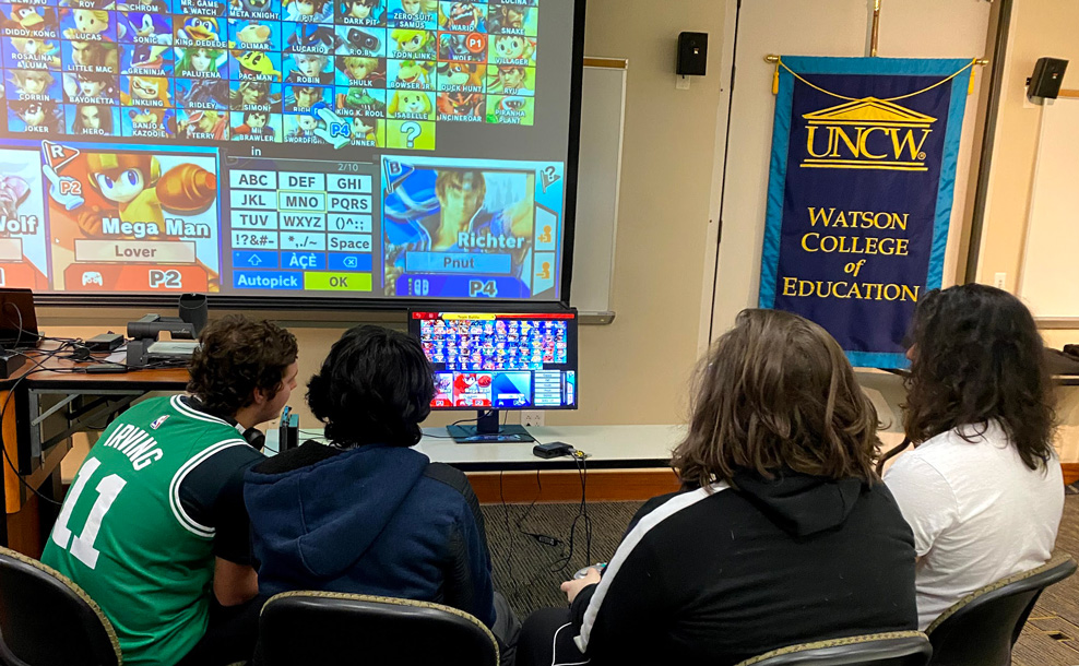 Students playing a video game on a projector screen