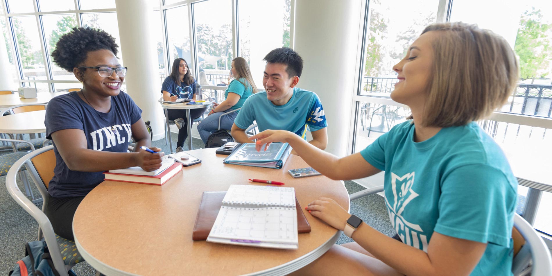 Group of Watson students collaborating at a desk