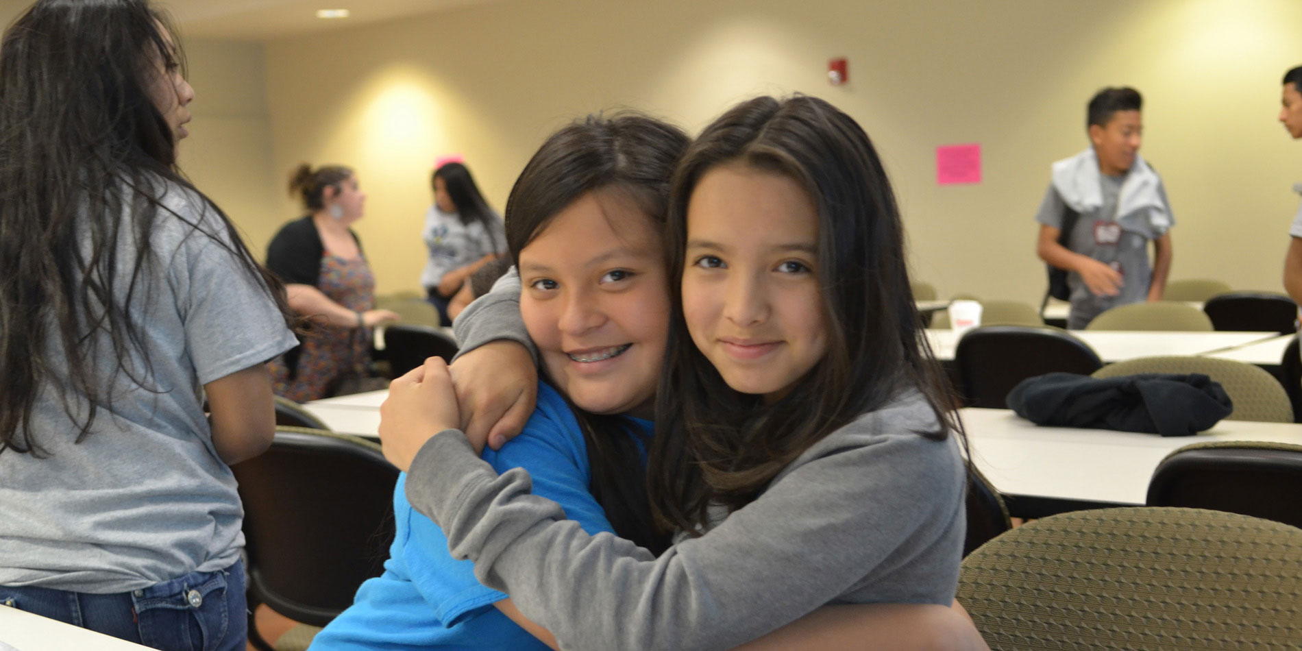 Two elementary students hugging