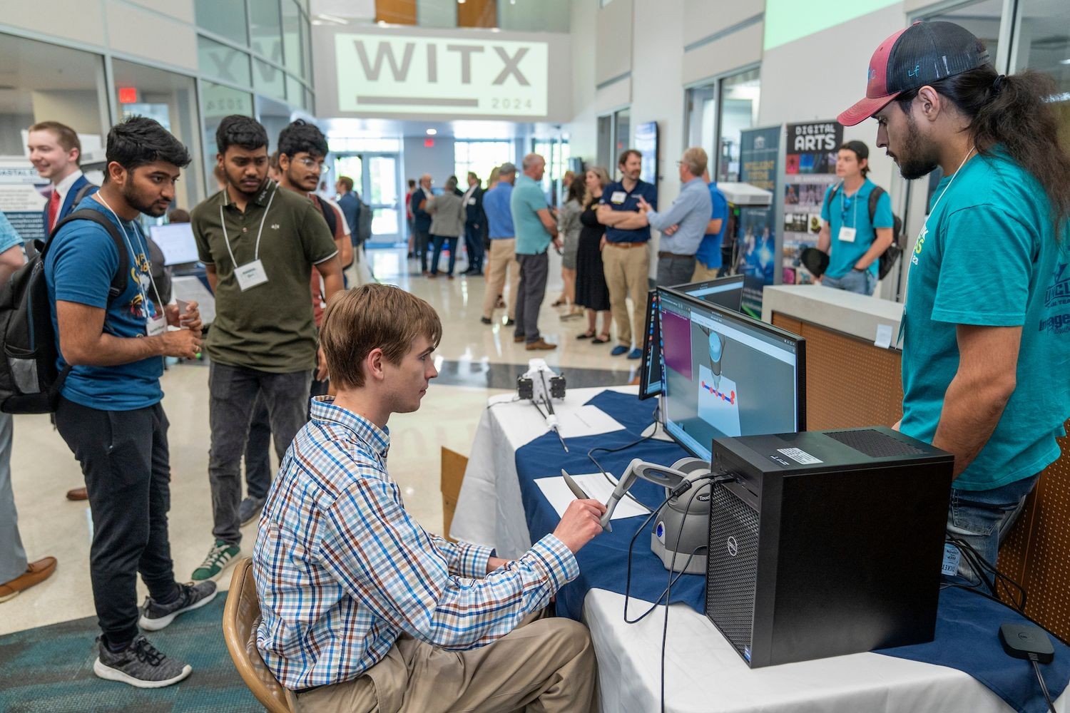 Students watching and learning new computer technology at a past WITX event.