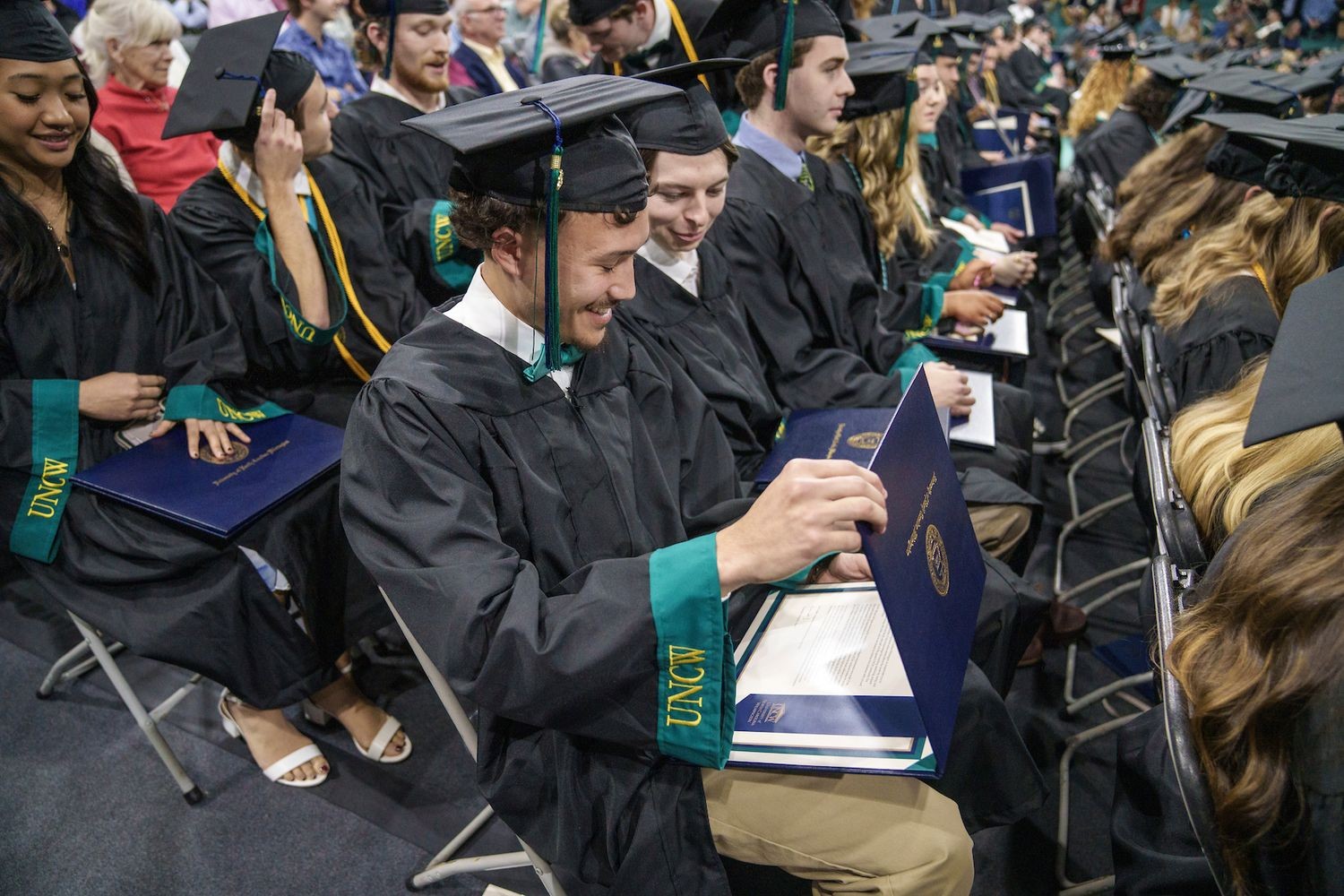Graduates receive their diplomas during commencement ceremonies in Trask Coliseum every December and May.