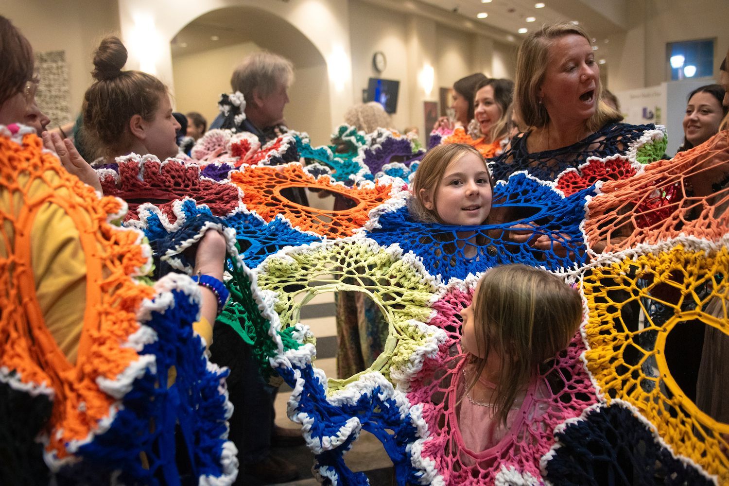 Children take part in an interactive textile sculpture in UNCW's Cultural Arts Building