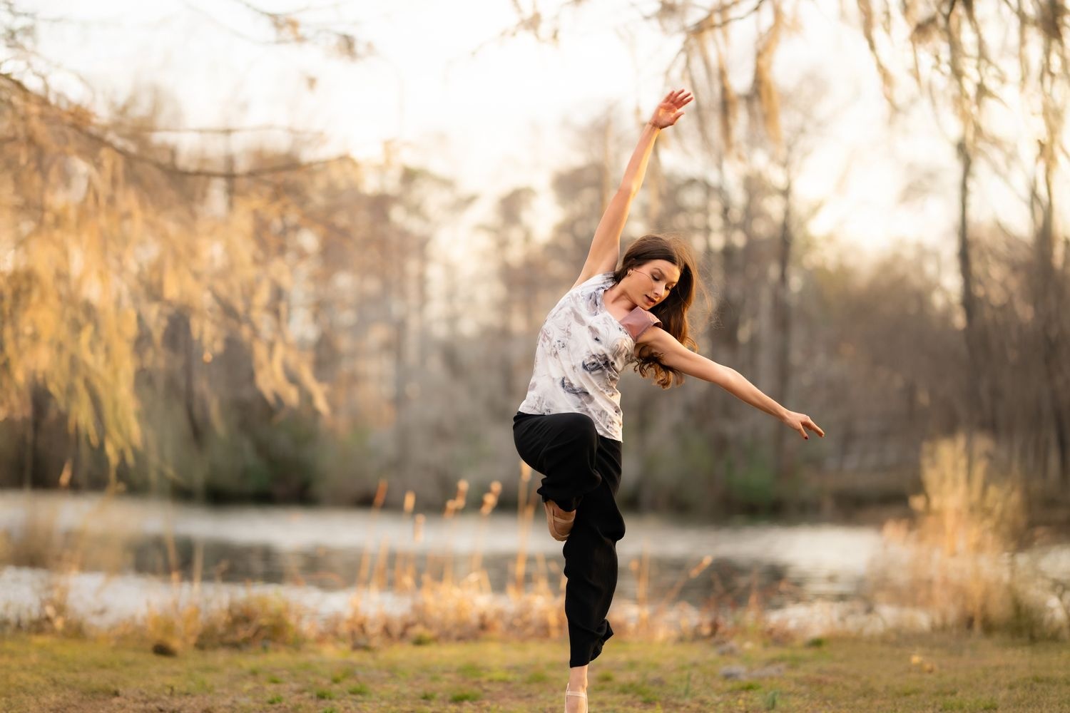 Student dancing near a lake