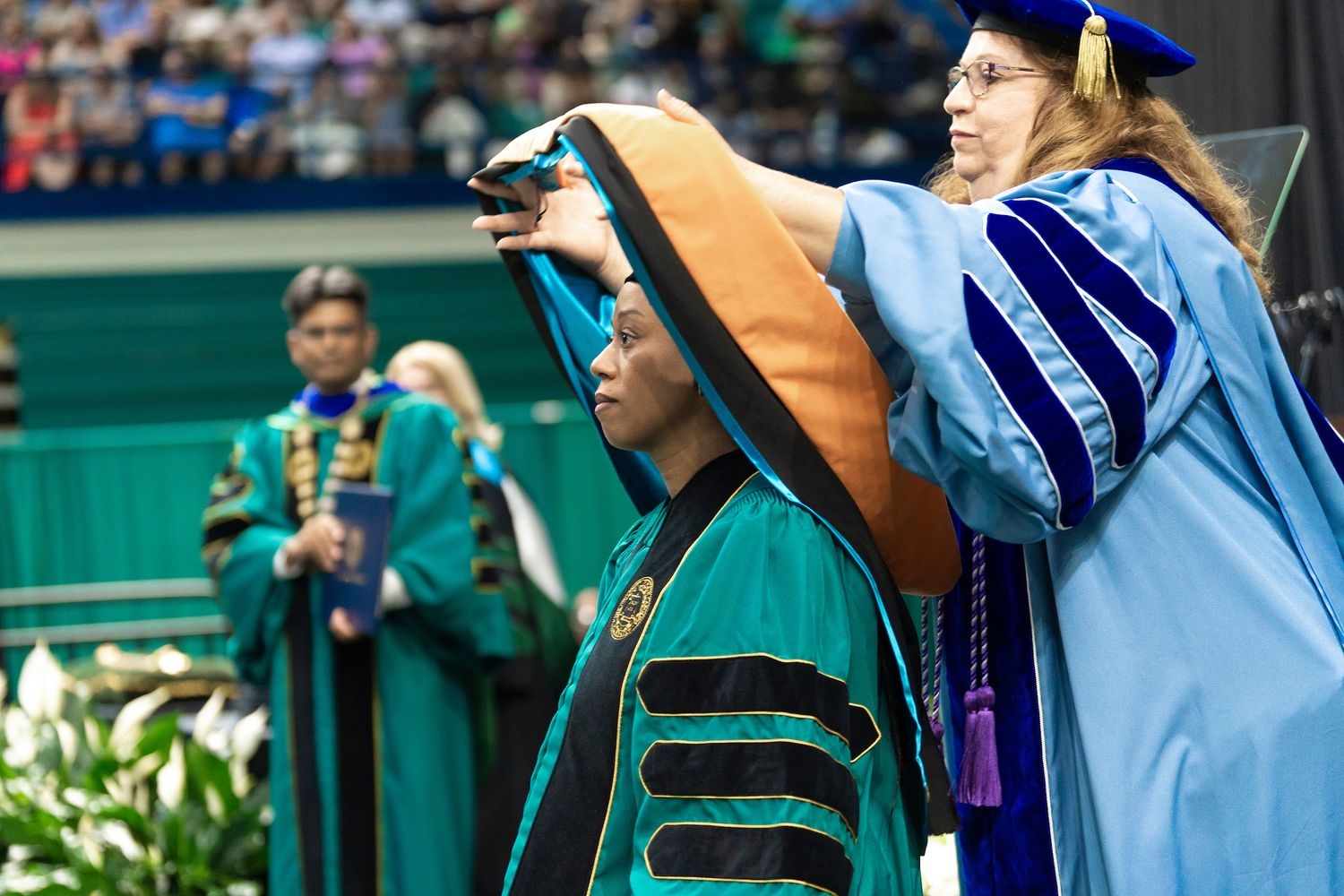 UNCW Doctoral graduates is hooded