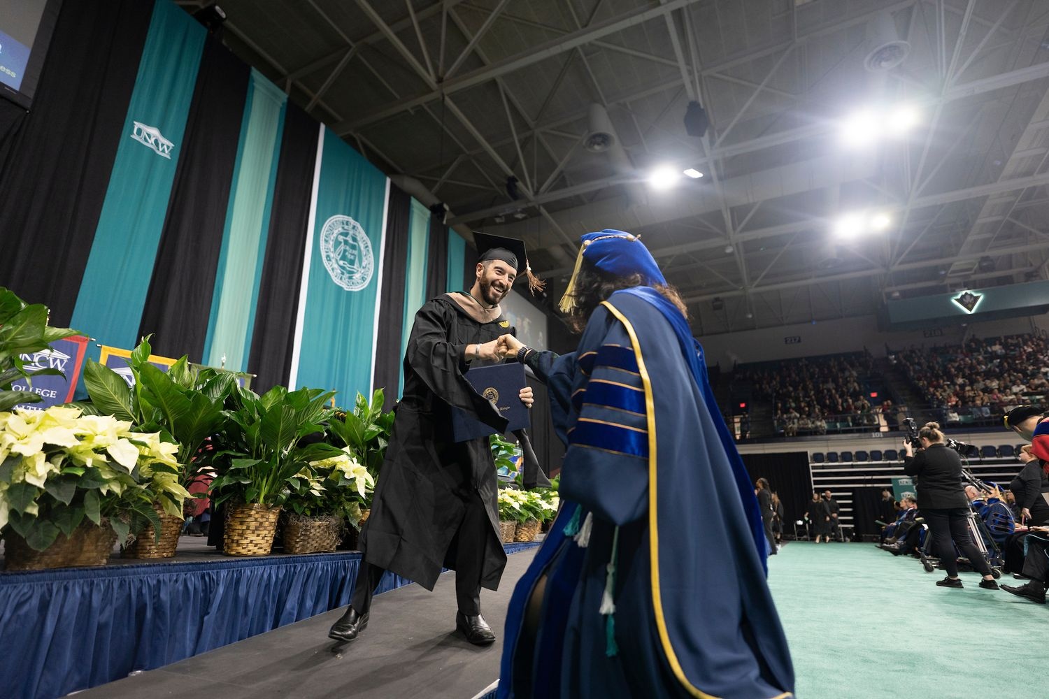 Excited student walks at commencement