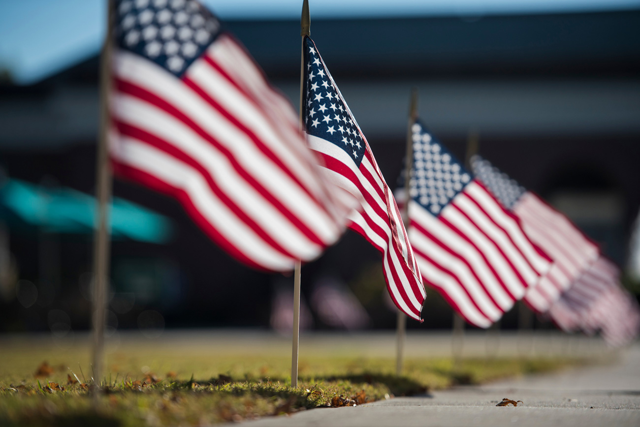 American flags fly on UNCW's campus