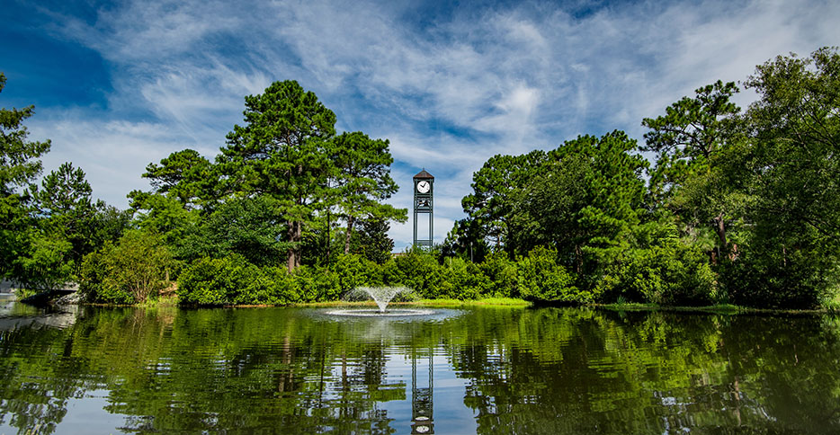 Clocktower surrounded by trees.