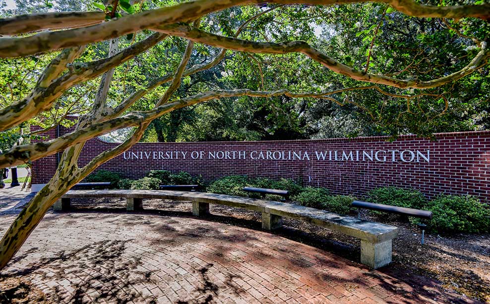 Brick entrance wall to campus, stating University of North Carolina Wilmington