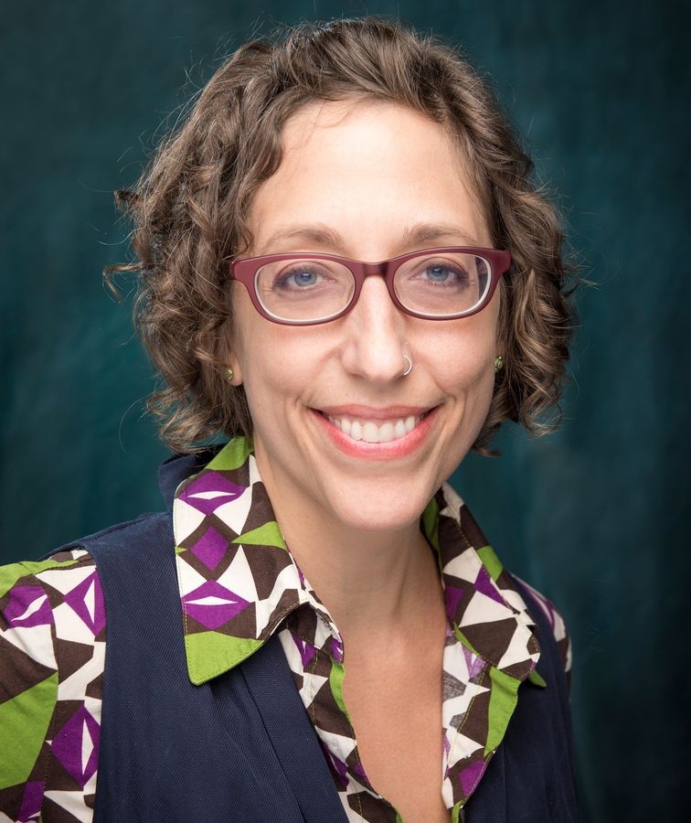 faculty member smiling in portrait