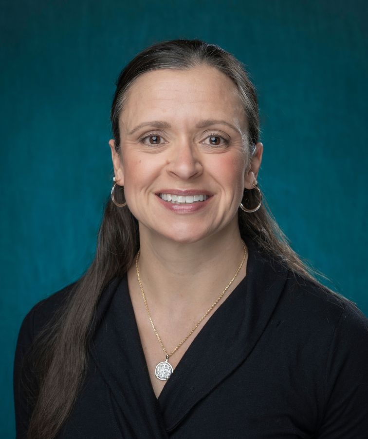 faculty member smiling in portrait