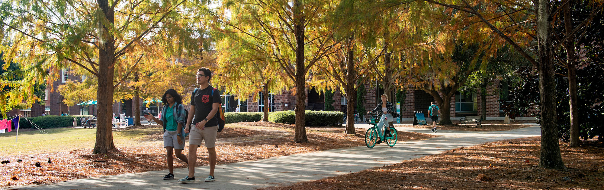 Students walking across campus during autumn