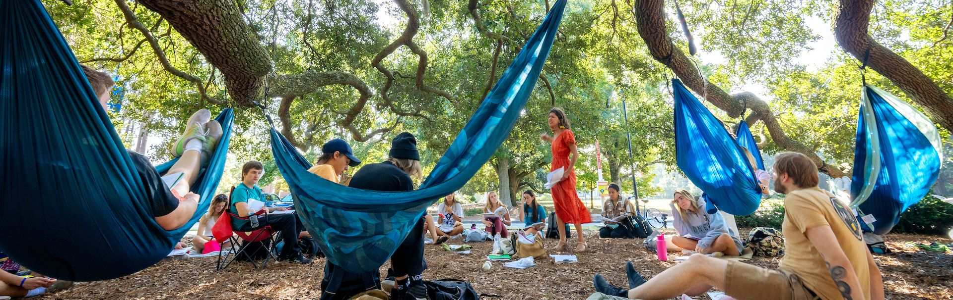 English class held outside and students sitting in hammocks