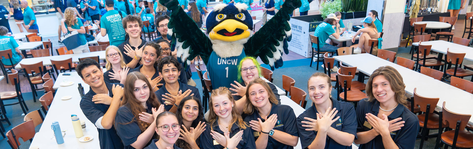 Members of the Class of 2024 giving 'Wings Up' salute during class photo.