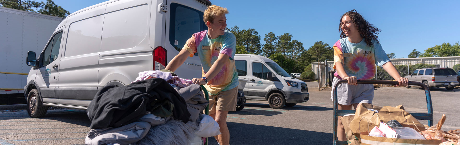 Two students moving their belongings on handtrucks