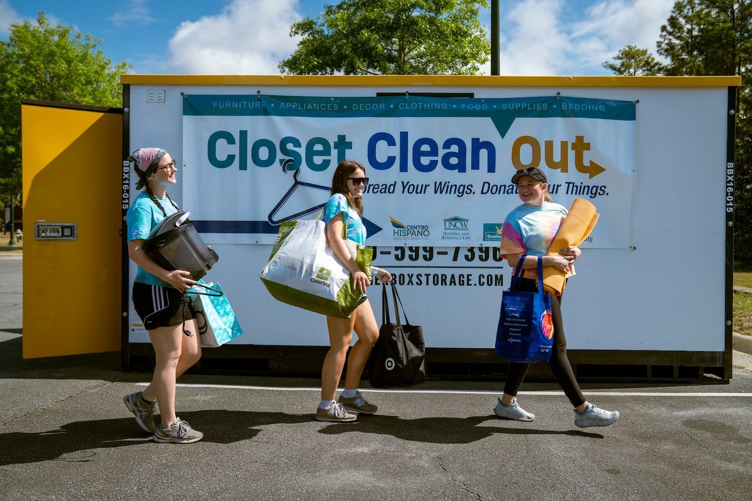 3 students moving their belongings