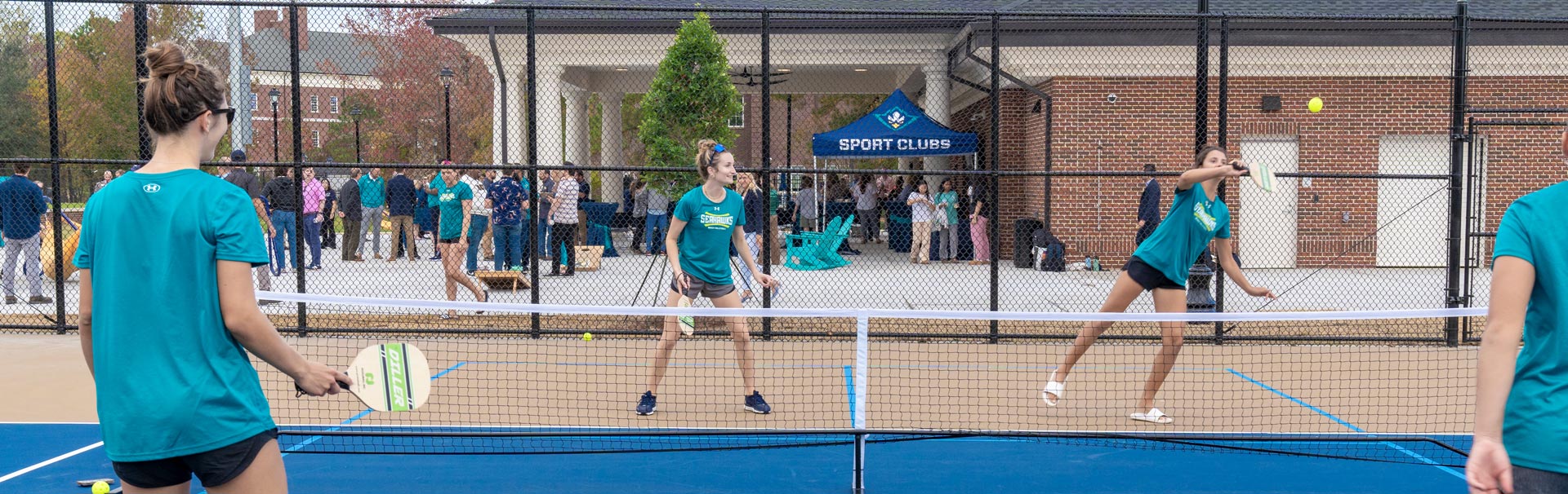People playing pickleball on tennis courts