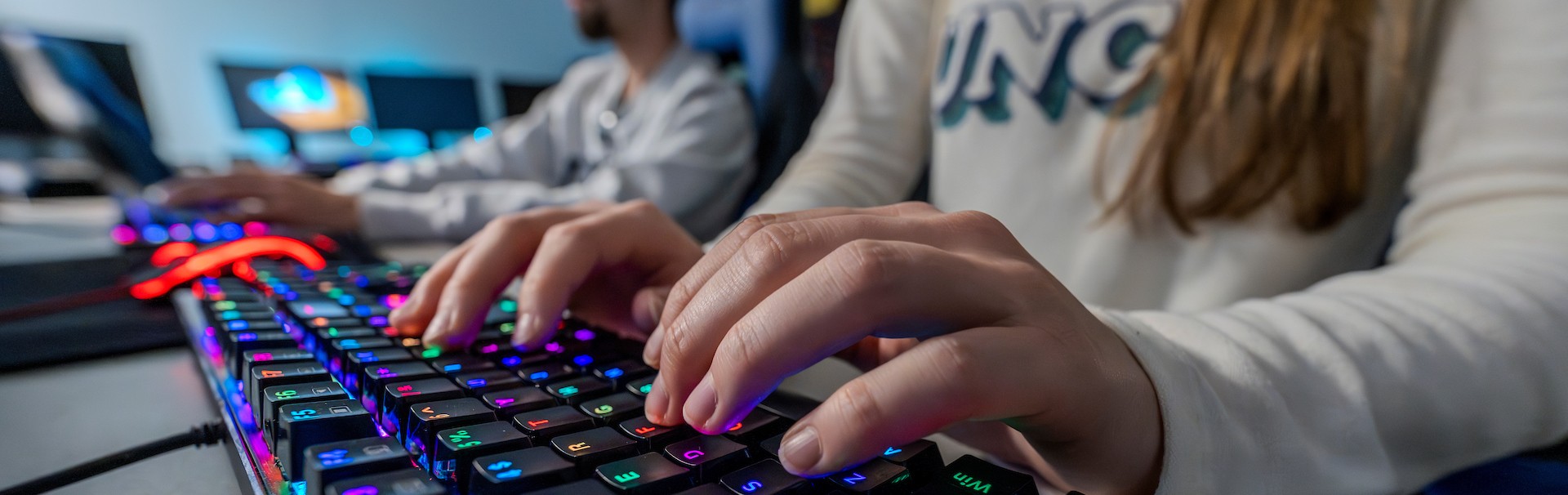 Person typing on light up rgb keyboard