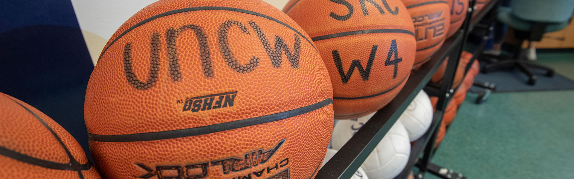 Sports equipment, mainly basketballs, is pictured