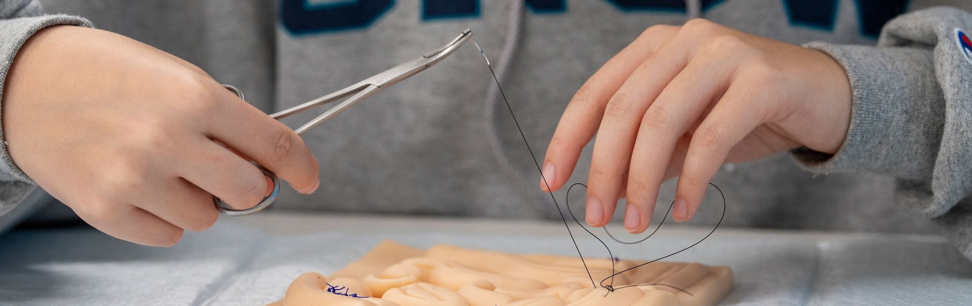 A student practices suturing 