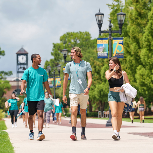 Students walking down a road on campus