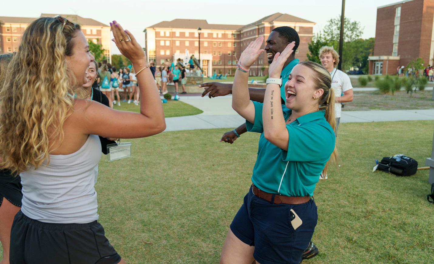 Students high-fiving at orientation