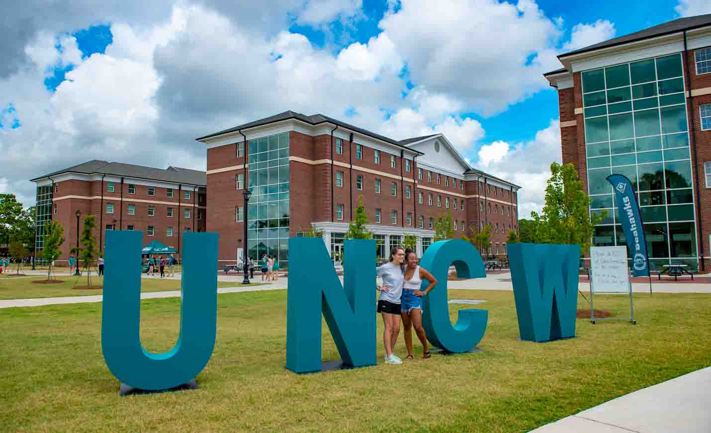Students gathered at the Quad Fields in front of giant UNCW letters.