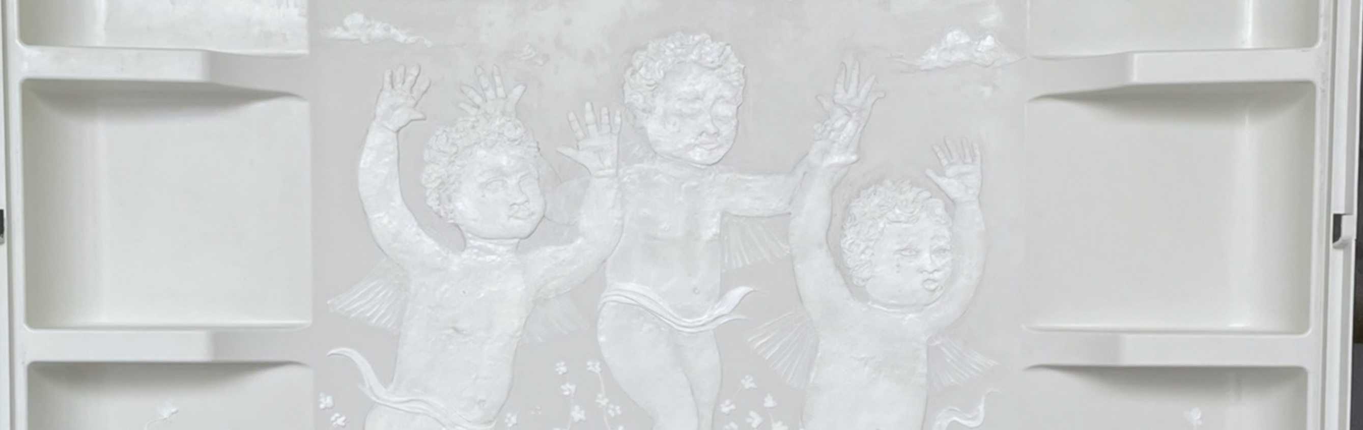 sculpted shower wall with three babies playing in a field