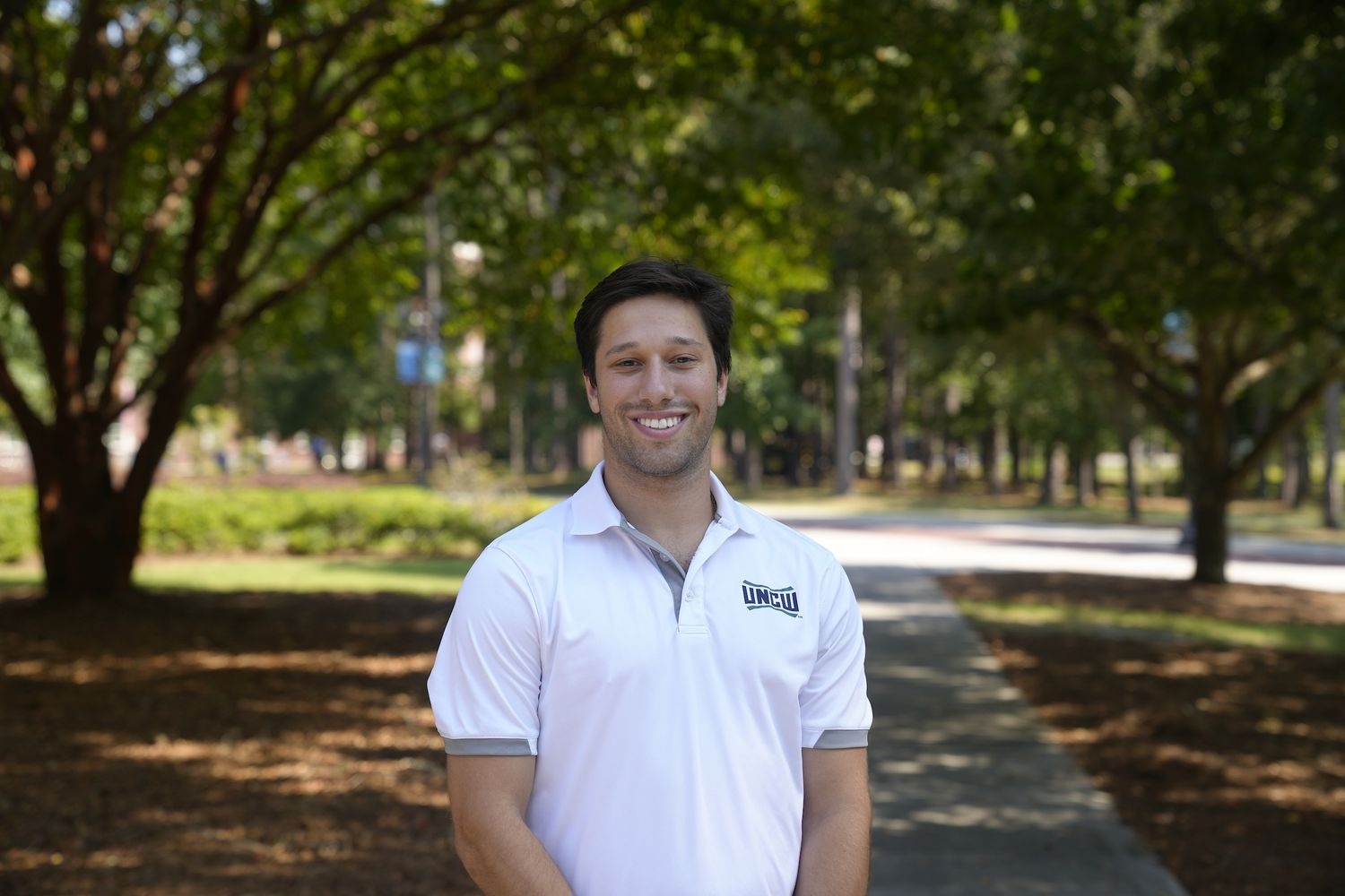 male with brown hair smiling