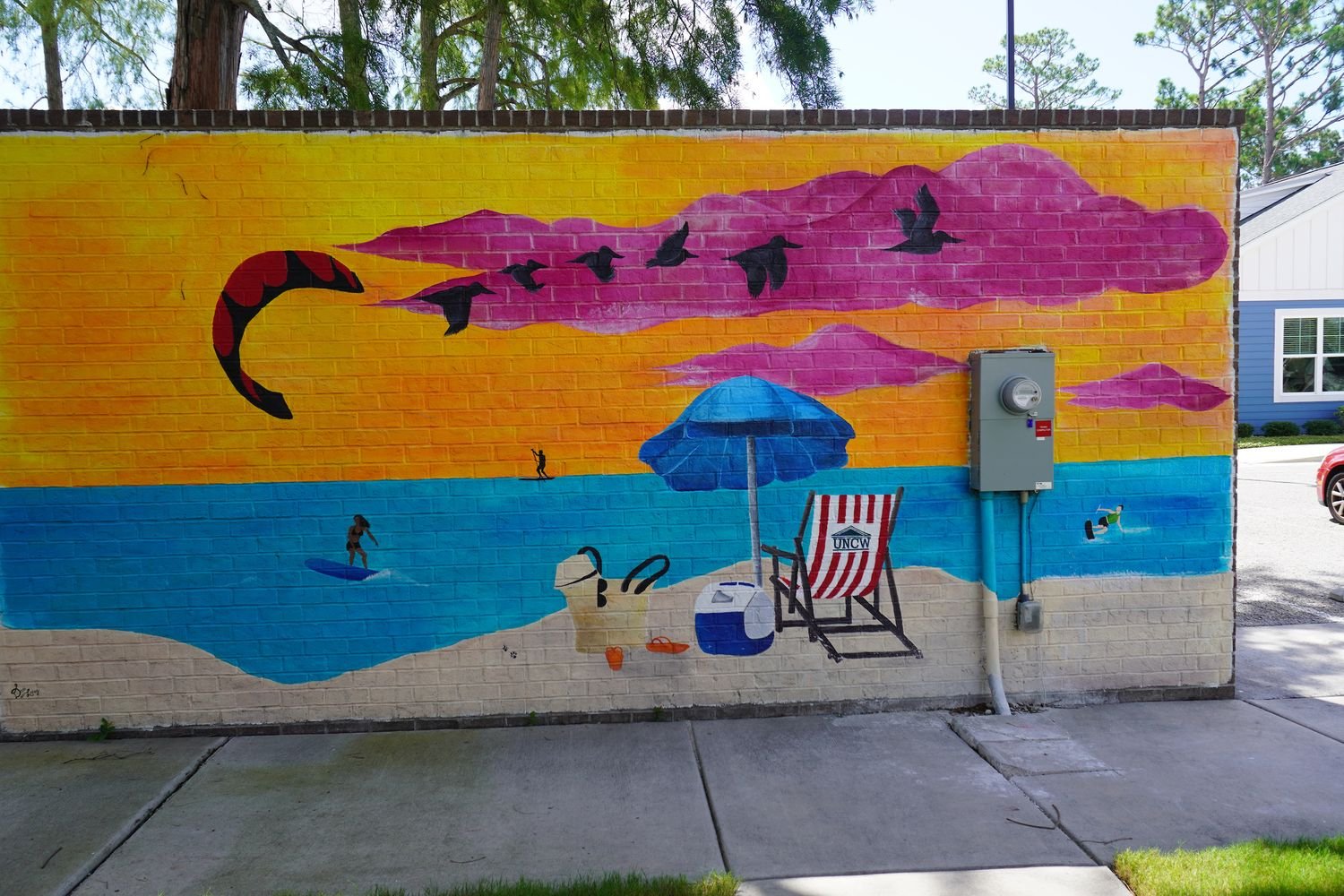 Mural artwork of a beach at the Cottages at College Acres