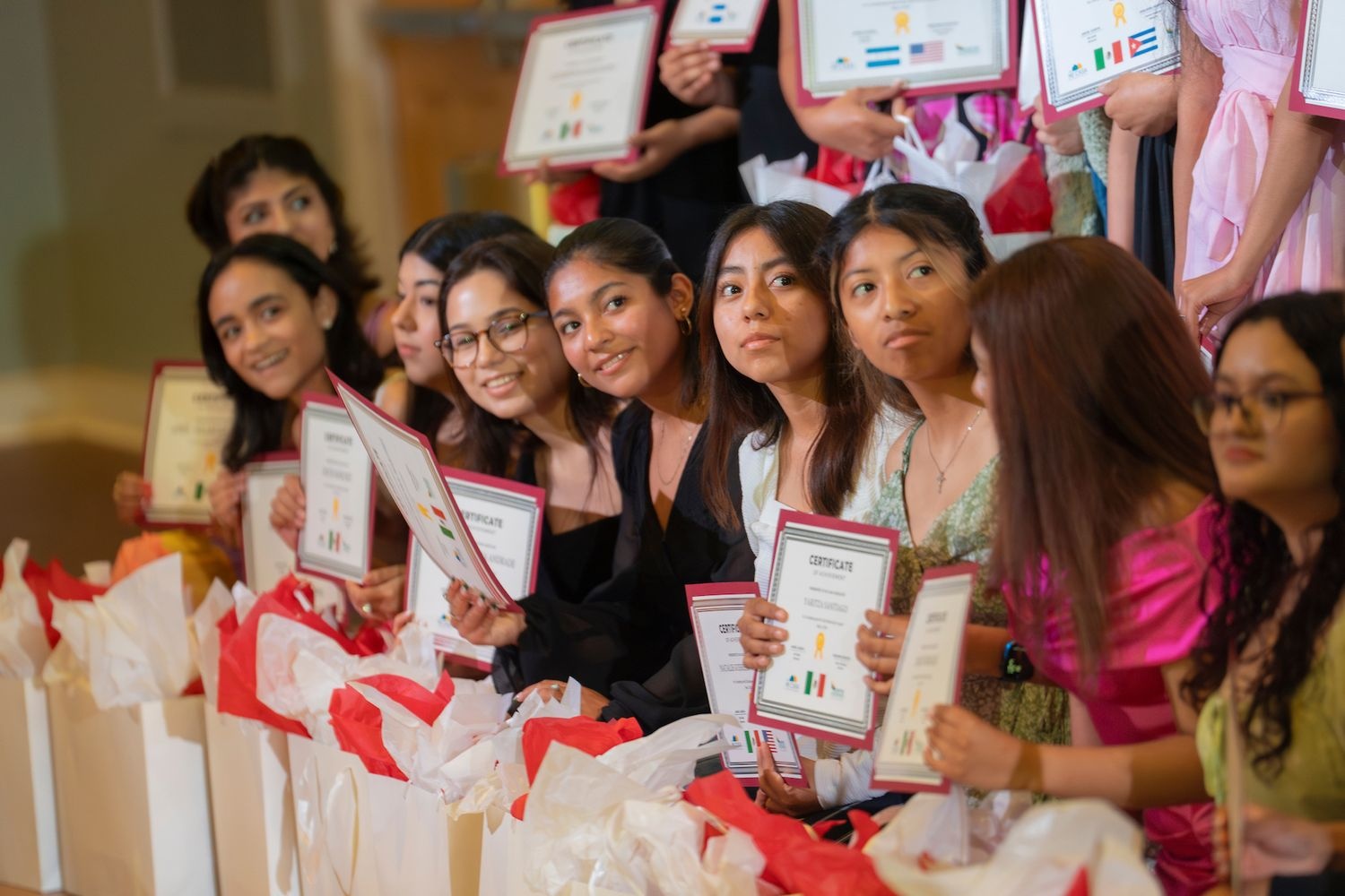 Students posing with their diplomas during the graduation ceremony