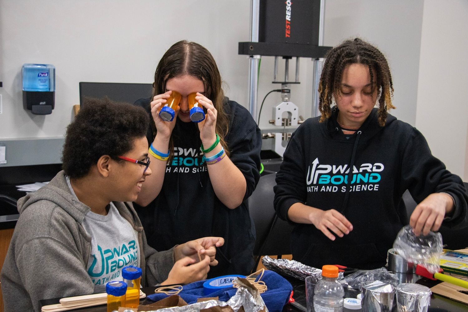 Students building boats with recycled materials