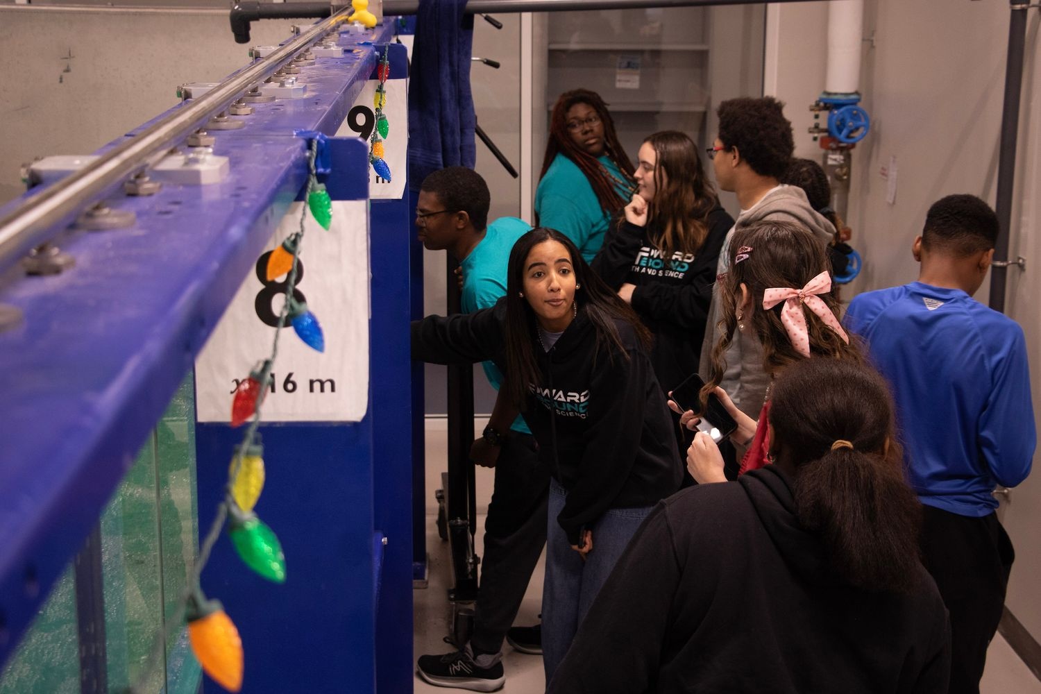 Students watching the boat competition in the wave simulator