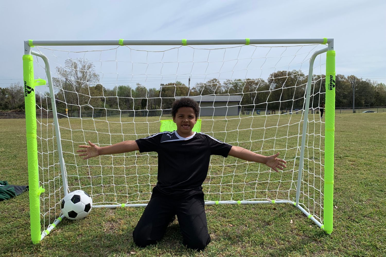 D.C. Virgo student in front of a new soccer net
