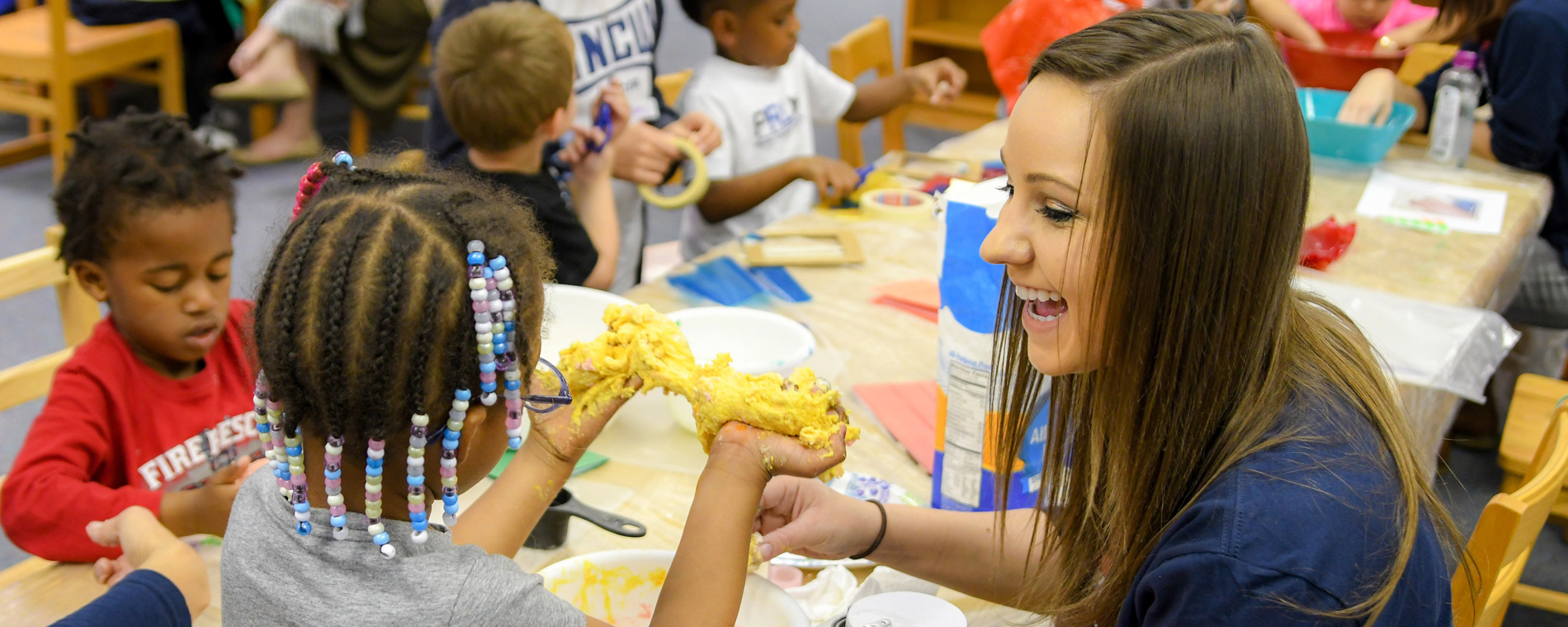 Teacher helps with crafts