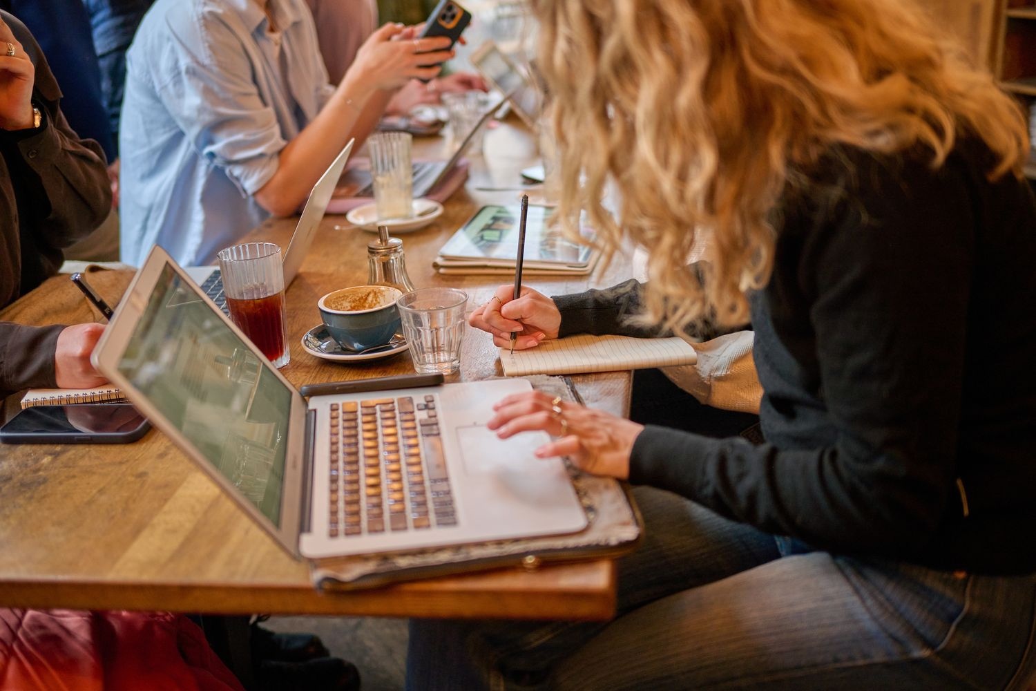 People working in a coffee shop with laptop computers