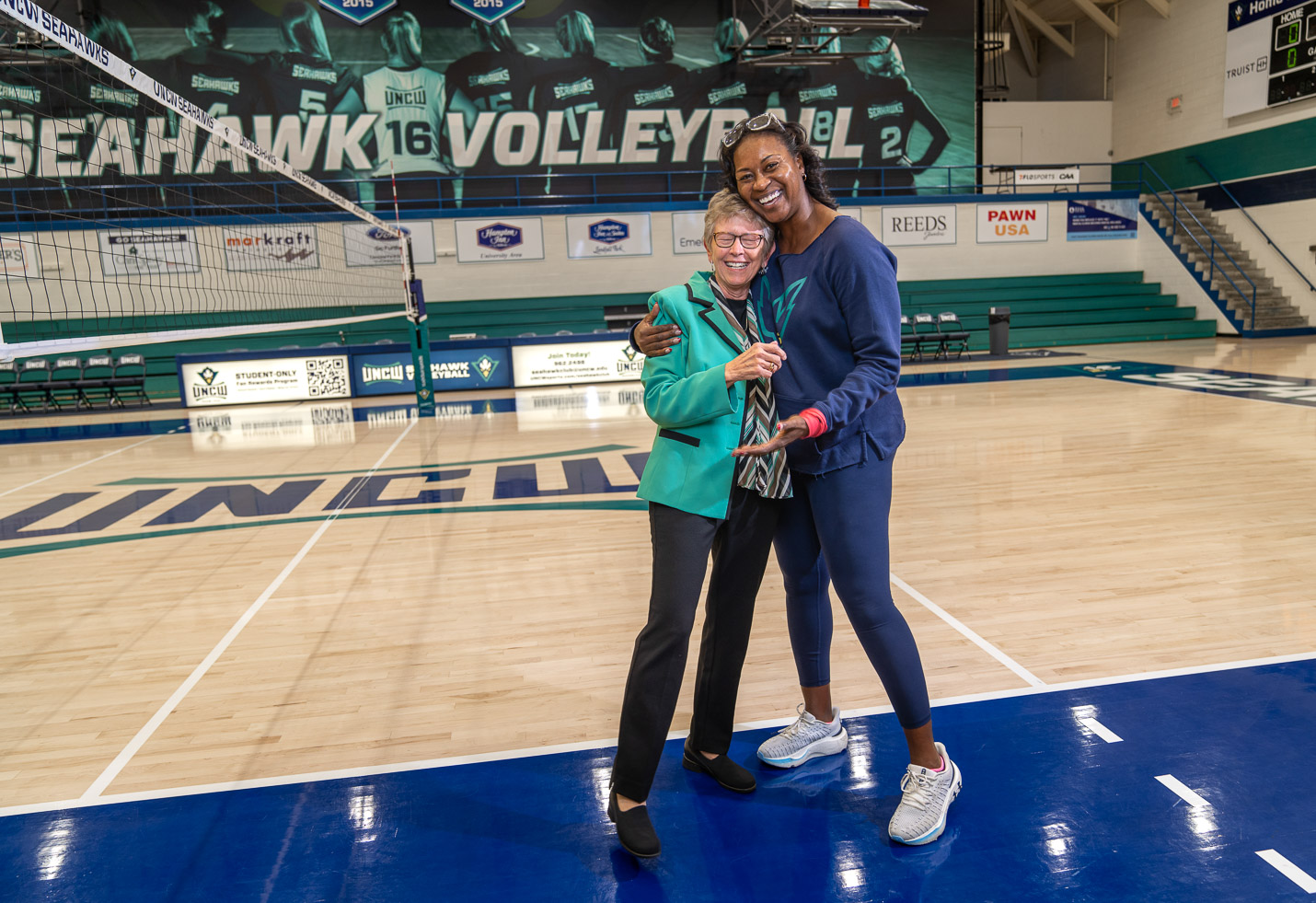 UNCW Women's Volleyball Head Coach Dartanya Hampton (right) credits Jan Donahue with providing women with opportunities to compete in college athletics at UNCW.