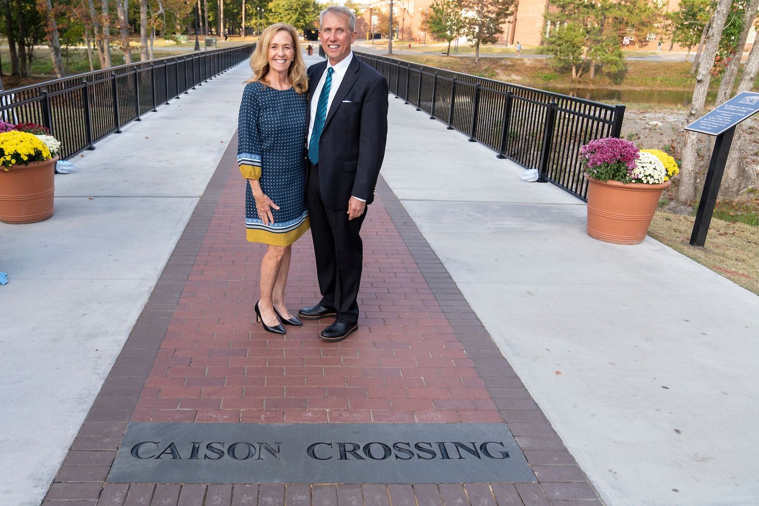 Hugh ’85 and Nan ’83 Caison on the pedestrian bridge that bears their name.