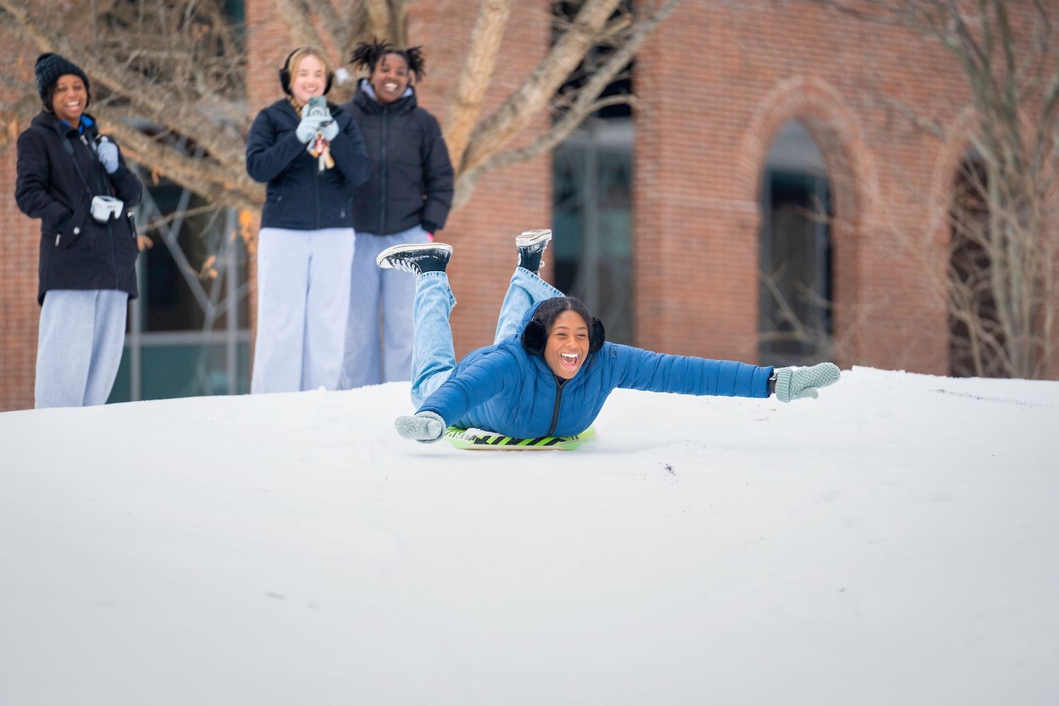 Students sledding on slow