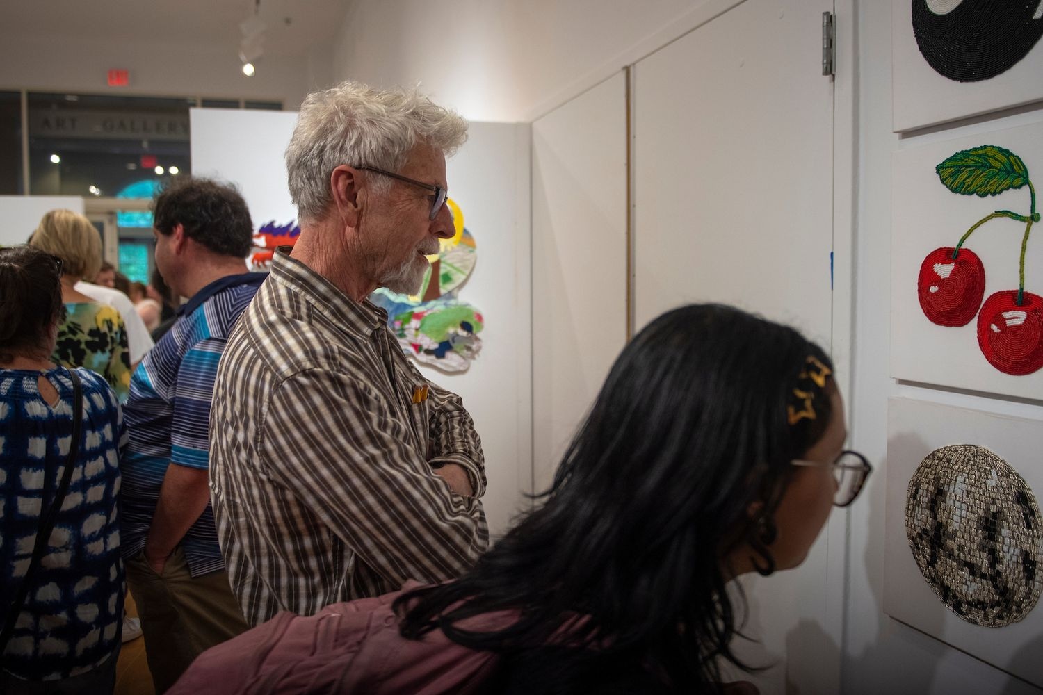 Patrons admiring works of art in a gallery